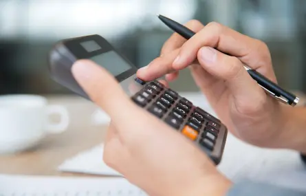 A person using a calculator to record financial transactions.